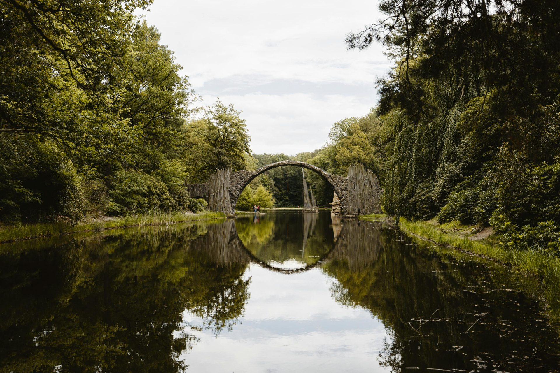 Spiegelnde Ansicht der Rakotzbrücke, einer mystischen Steinbrücke im Kromlauer Park, Deutschland.